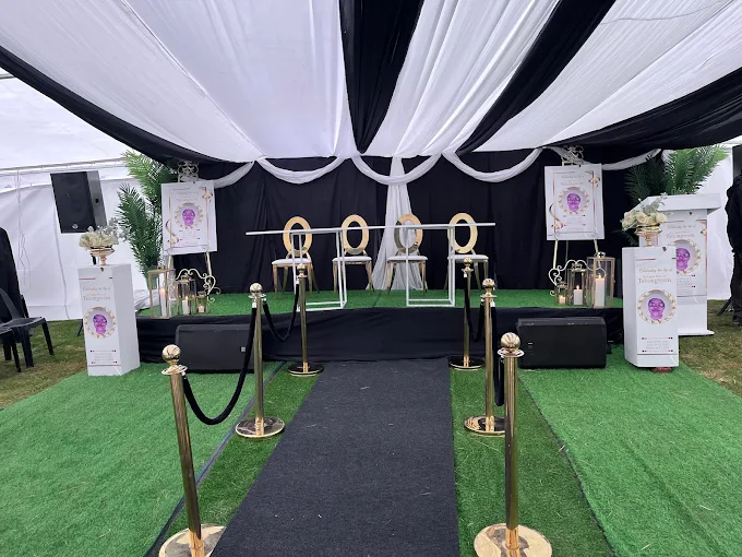 A formal Panthera memorial service setup with aisle and floral tributes